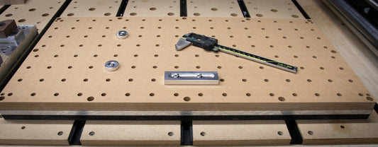 Cnc router fixture plate with some tools and calipers showing size