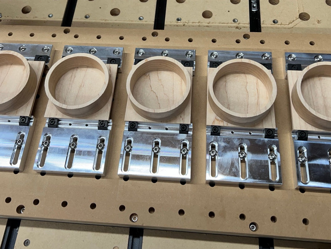 5 parts being heled with railcamps on the PGC Gridplate cnc router fixture plate
